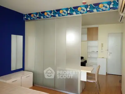 Modern bedroom with sliding glass closet doors and stylish decor