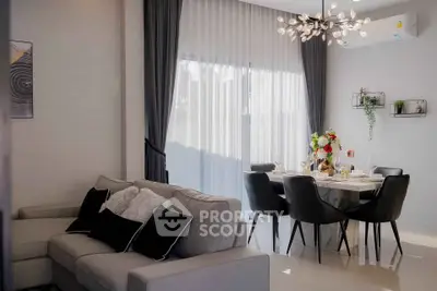 Modern living and dining area with elegant decor and natural light
