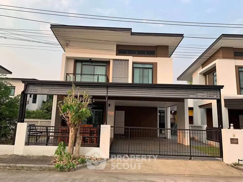 Modern two-story house with sleek design and spacious carport in a suburban neighborhood.