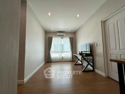 Spacious modern living room with wooden flooring and natural light