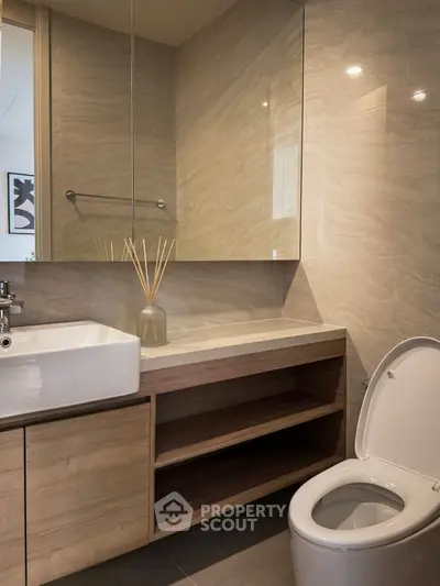 Modern bathroom with sleek design, featuring a stylish sink and toilet, perfect for contemporary living.