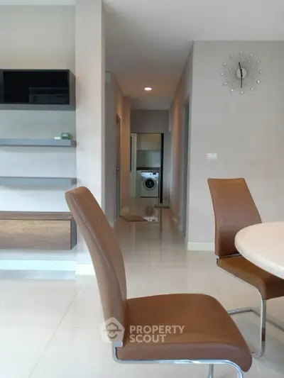 Modern apartment interior with sleek furniture and washing machine in hallway