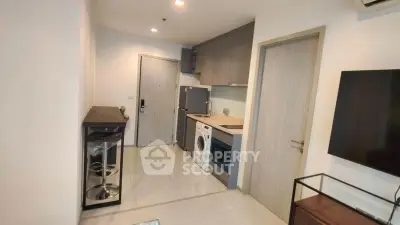 Modern apartment interior with compact kitchen and washing machine