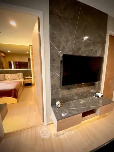 Modern bedroom with sleek TV setup and elegant decor