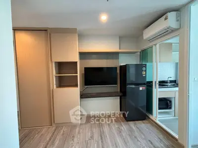 Modern apartment interior with sleek kitchen and built-in storage, featuring a stylish open layout.