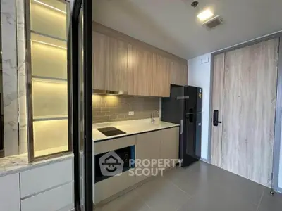 Modern kitchen with sleek cabinetry and built-in appliances in a stylish apartment.