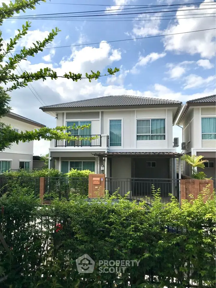 Charming two-story house with lush garden and modern design in a serene neighborhood.