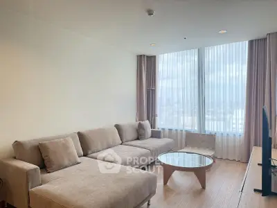 Spacious modern living room with large windows and stylish furniture