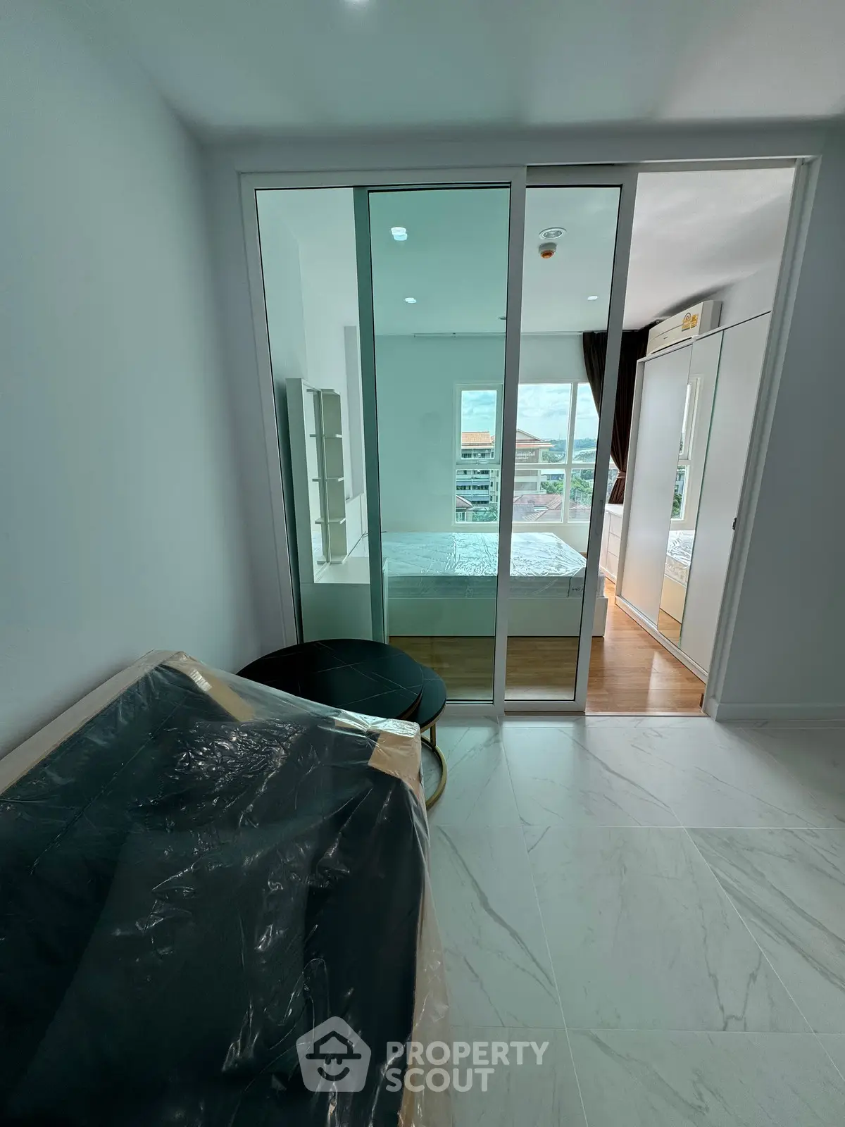 Modern bedroom with glass partition and natural light