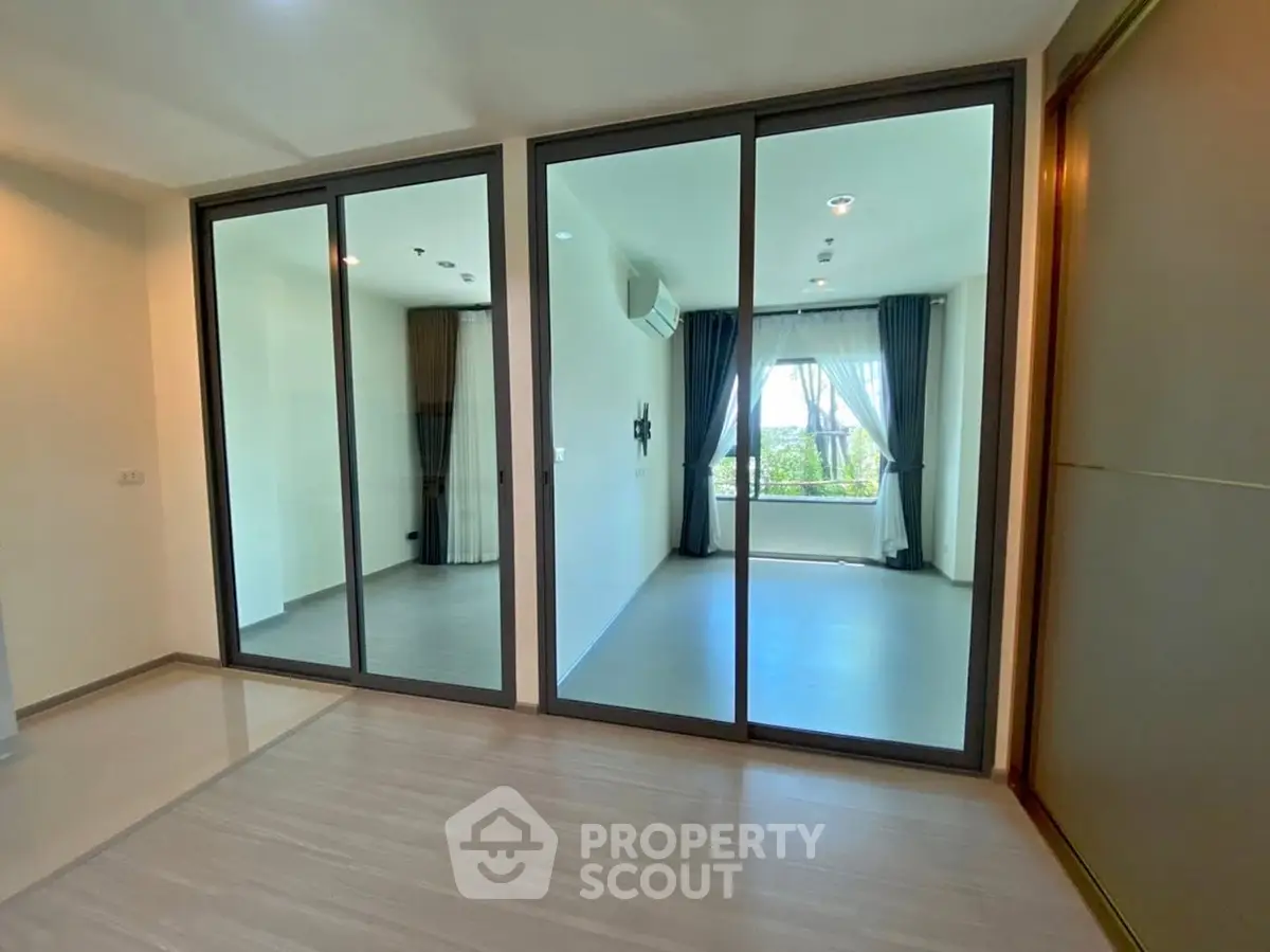 Spacious modern living room with glass partitions and natural light