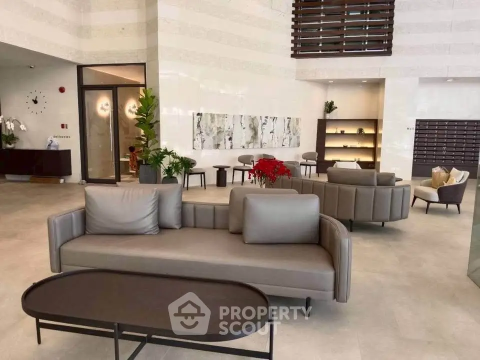 Luxurious modern lobby with elegant seating and contemporary decor in a high-end residential building.