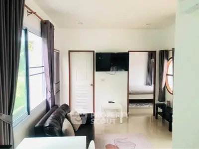 Bright and cozy living room with modern decor and large windows in a stylish apartment.