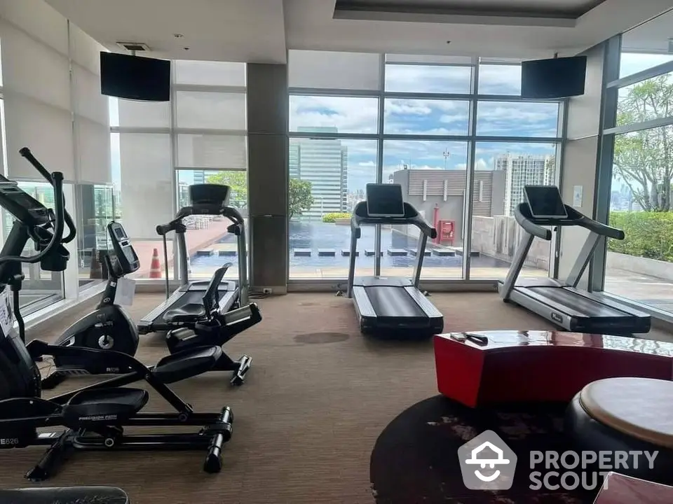 Modern gym with city view and state-of-the-art fitness equipment