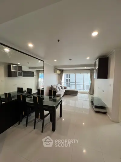 Spacious modern living room with elegant dining area and large windows for natural light.