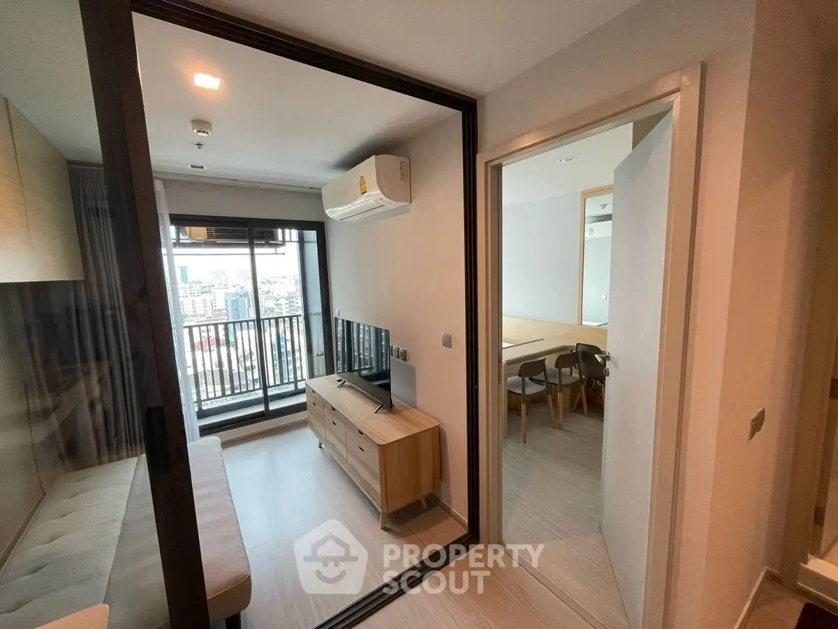 Modern apartment with balcony and city view, featuring sleek interior design and open layout.