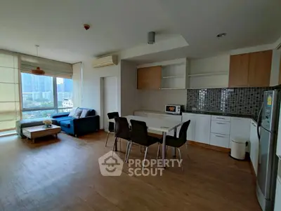 Spacious open-plan living room with modern kitchen and city view