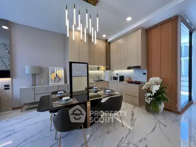 Luxurious modern kitchen with elegant dining area and stylish lighting