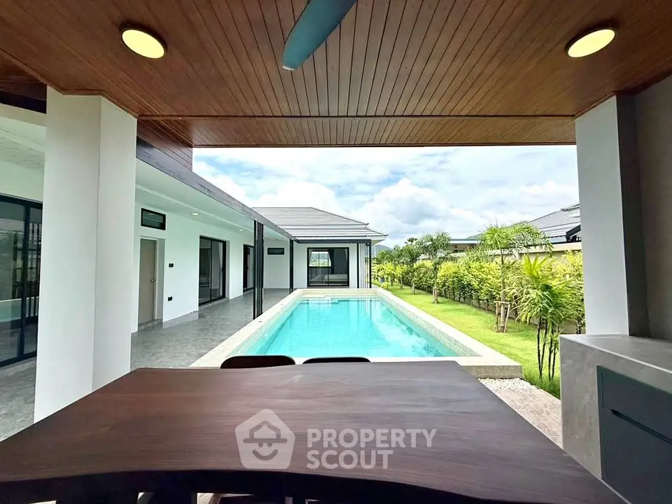 Luxurious modern villa with private pool and lush garden view, perfect for relaxation and entertaining.