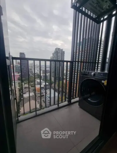 Modern balcony with city view and washing machine, perfect for urban living.