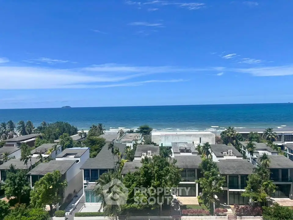 Stunning oceanfront view from luxury beachfront properties with lush greenery and clear blue skies.
