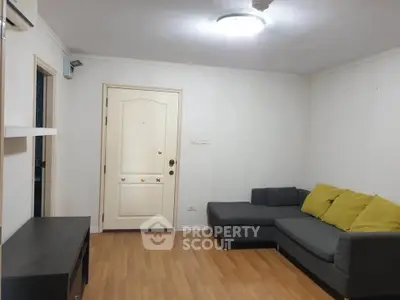 Cozy living room with modern gray sofa and wooden flooring