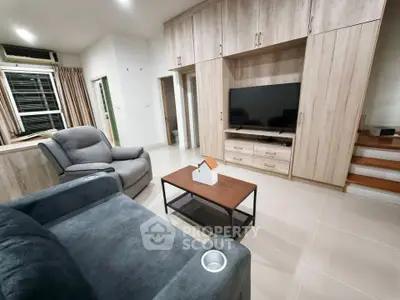 Modern living room with stylish furniture and built-in storage, perfect for cozy relaxation.