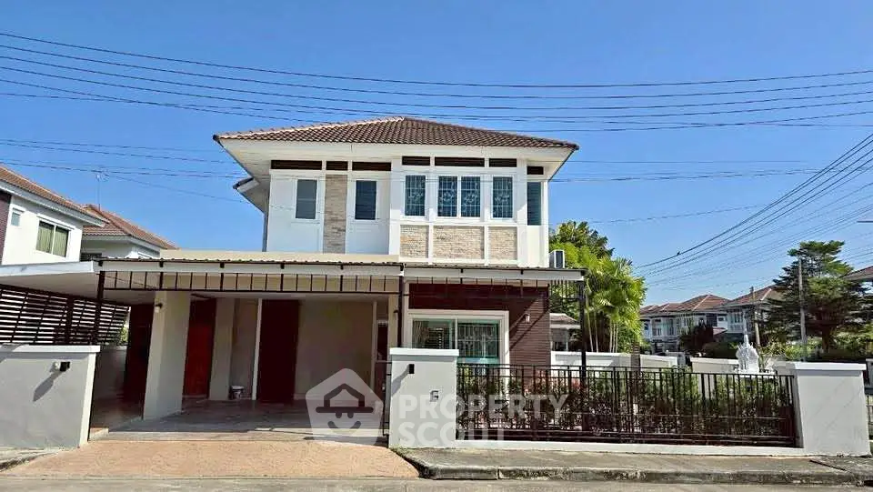 Charming two-story house with modern design and spacious driveway in a serene neighborhood.