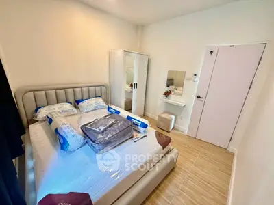Cozy bedroom with modern furnishings and ample natural light