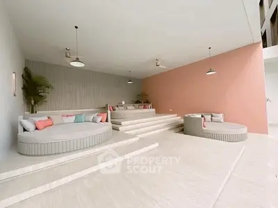 Modern living room with stylish circular seating and pastel accents