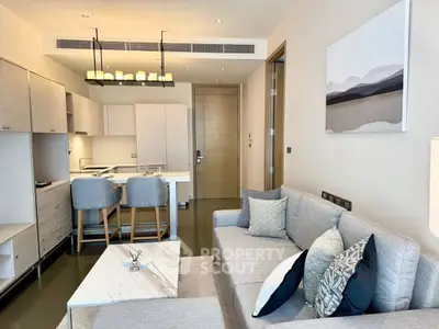 Modern living room with stylish decor and open kitchen layout.