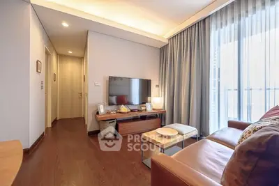 Modern living room with sleek furniture and large TV, featuring elegant lighting and floor-to-ceiling curtains.