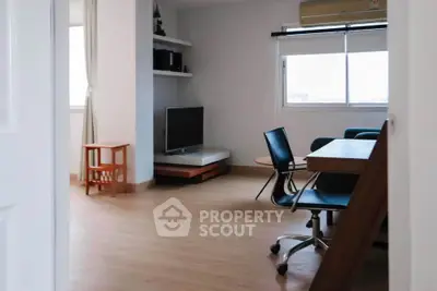 Modern living room with sleek furniture and natural light, perfect for relaxation and entertainment.