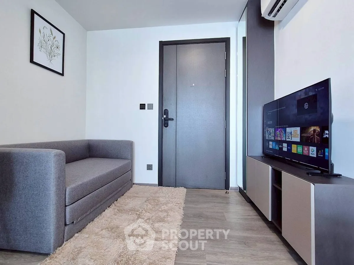 Modern living room with sleek furniture and wall-mounted TV, perfect for cozy relaxation.