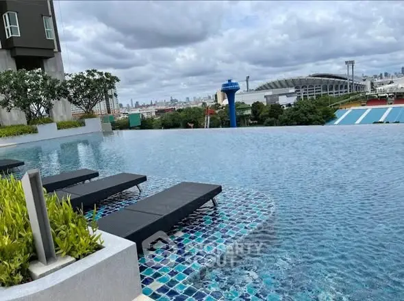 Luxurious rooftop infinity pool with stunning city skyline view.