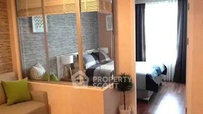 Modern bedroom with stylish decor and natural light, featuring cozy seating area and elegant design.