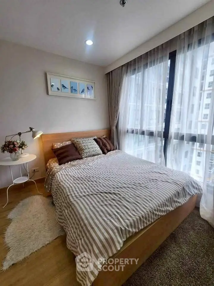 Cozy bedroom with large windows and stylish decor in modern apartment