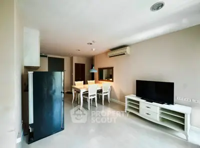 Spacious living room with modern furniture and air conditioning in a stylish apartment.