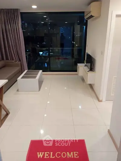 Modern living room with sleek design and city view, featuring a cozy sofa and stylish decor.
