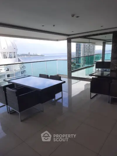 Luxurious balcony with stunning ocean view and modern outdoor furniture