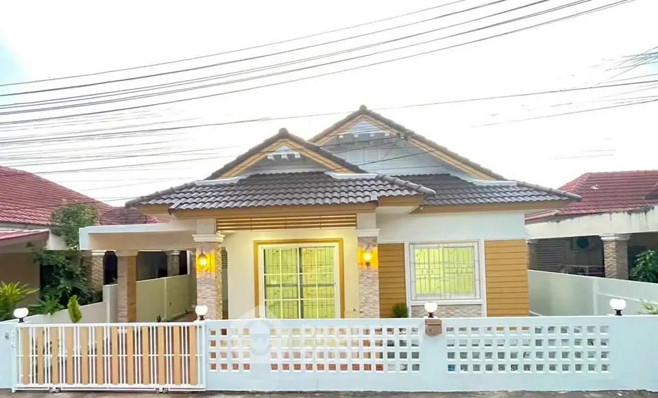 Charming single-story house with modern facade and gated entrance