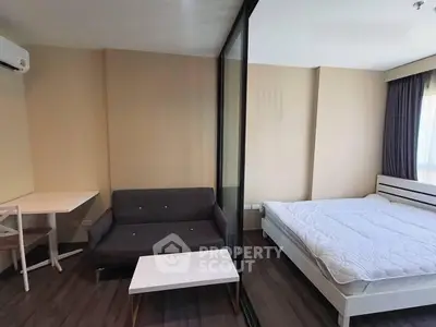 Modern studio apartment with cozy living area and comfortable bed