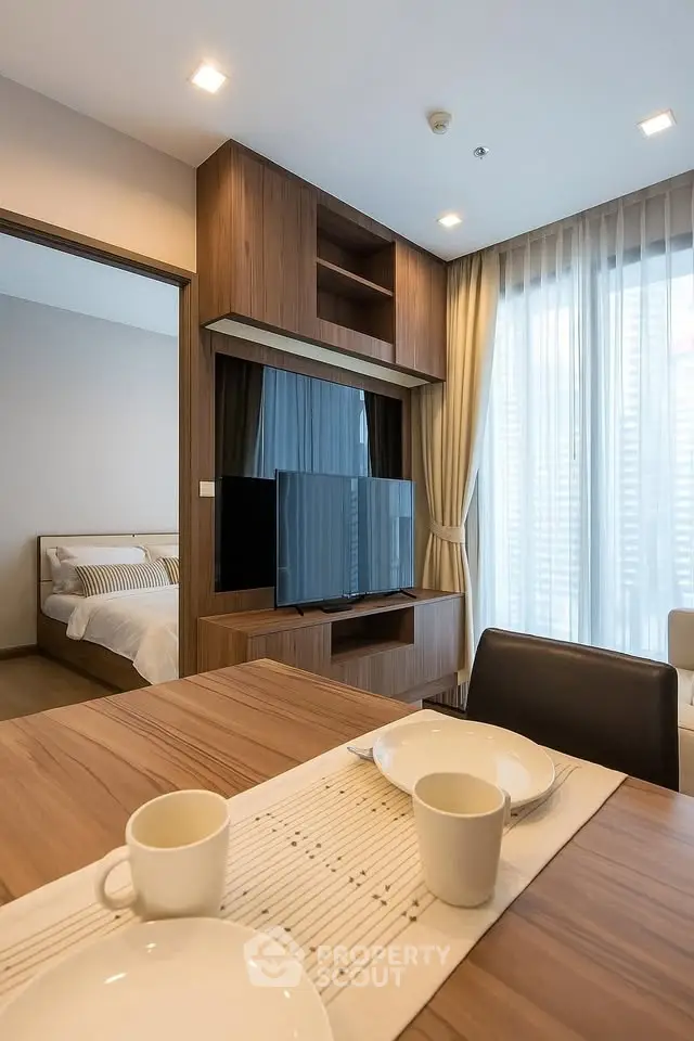 Modern living room with stylish wooden furniture and cozy bedroom view
