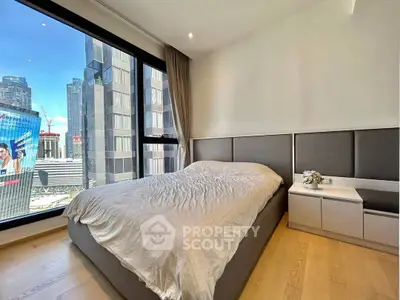 Modern bedroom with city view, featuring sleek design and large windows for natural light.