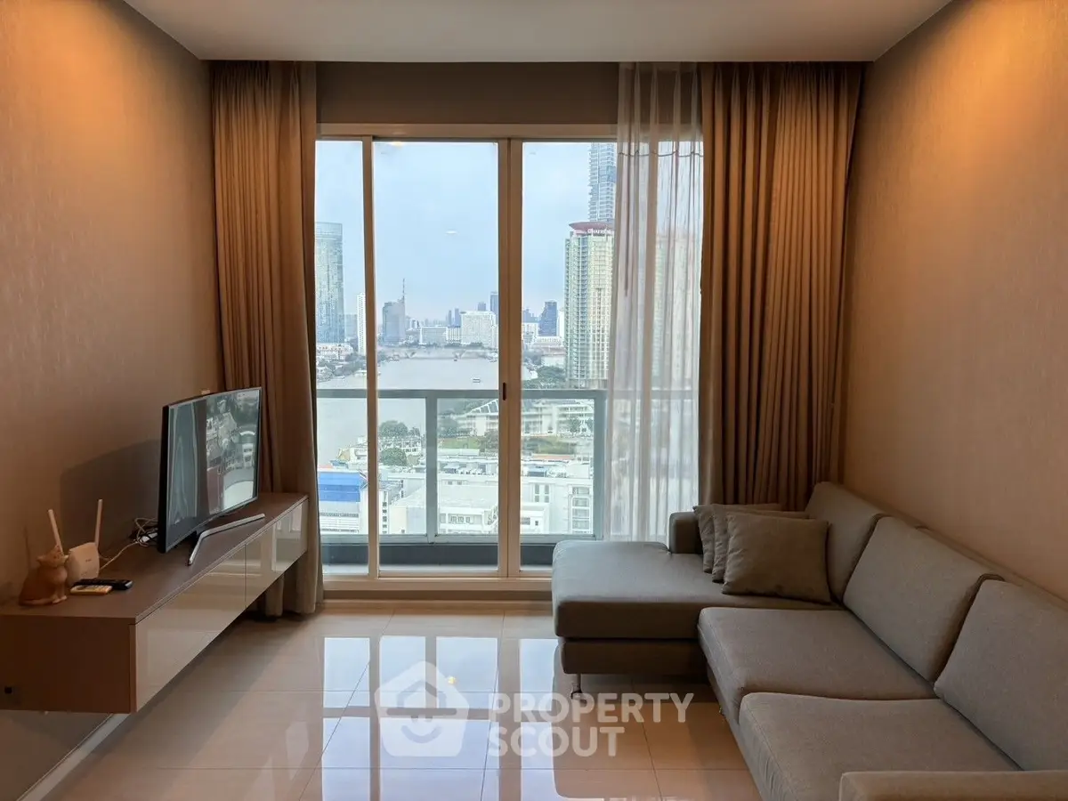 Modern living room with large window offering stunning city view, featuring sleek furniture and elegant decor.