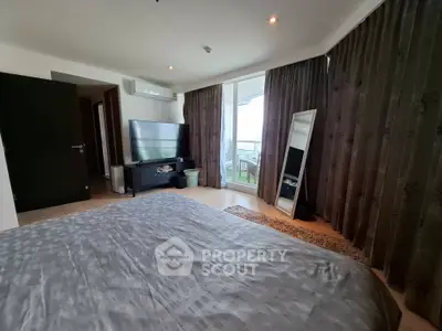 Spacious bedroom with balcony access and modern decor