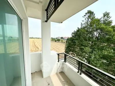 Charming balcony with serene countryside view, perfect for relaxation and enjoying nature's tranquility.