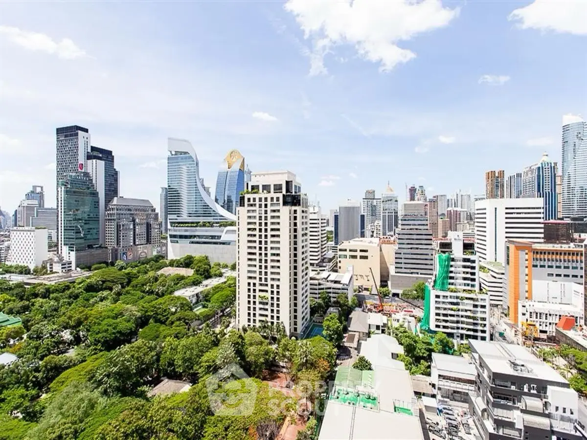 Stunning cityscape view showcasing modern skyscrapers and lush greenery in a vibrant urban setting.