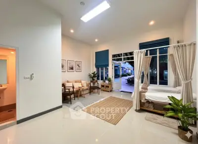 Spacious living room with modern decor and large windows for natural light