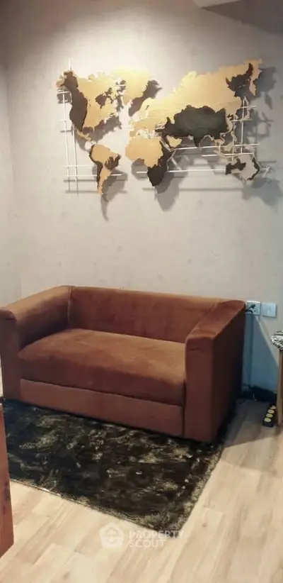Cozy living room with brown sofa and world map wall art, perfect for relaxation and style.