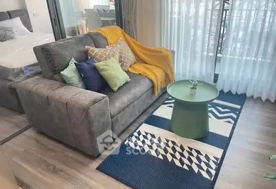 Modern living room with stylish sofa and vibrant decor in a cozy apartment.